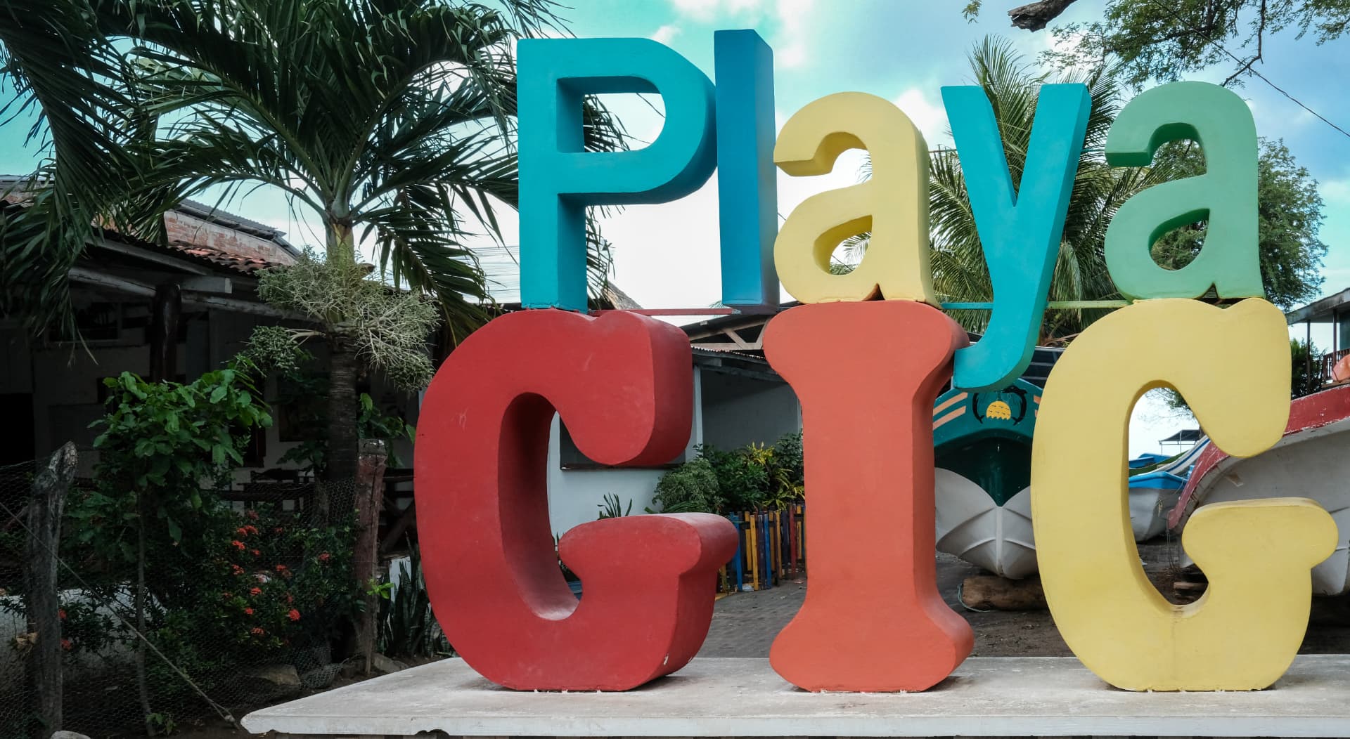 Colorful Playa Gigante letter sculpture beside palms in the village of Gigante, Nicaragua